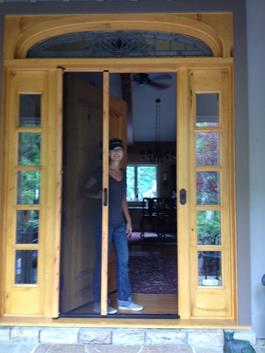 ClearView retractable screen door in powder-coated housing